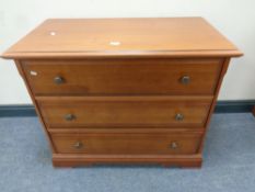A pair of contemporary three drawer chests in a teak finish