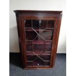 A 19th century inlaid mahogany astragal glazed corner cabinet