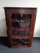 A 19th century inlaid mahogany astragal glazed corner cabinet