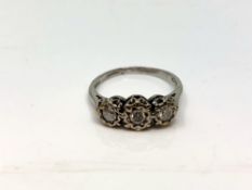 A 9ct white gold three stone diamond ring, size L CONDITION REPORT: 2.