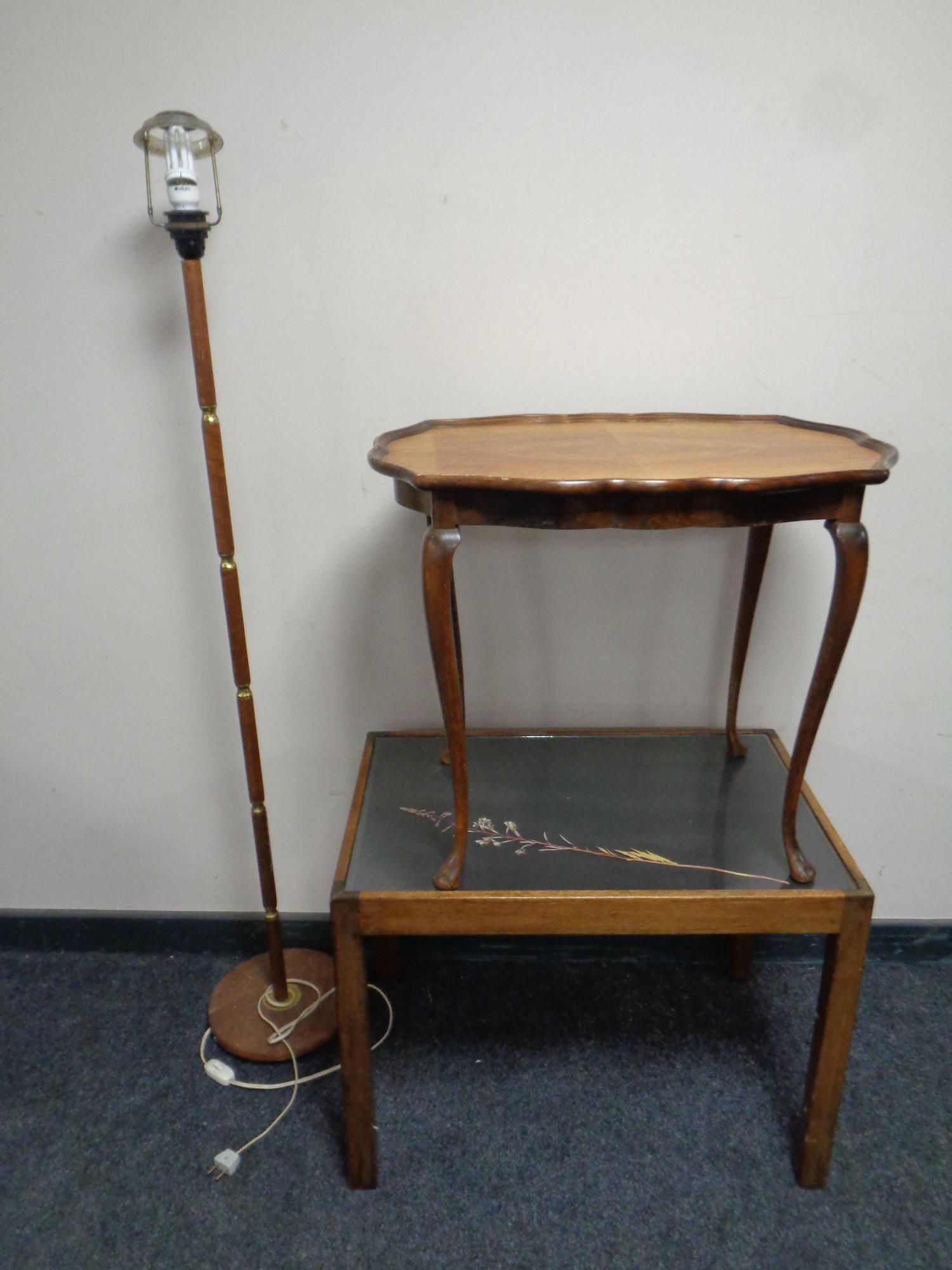 A walnut pie crust edge occasional table together with a further glass topped occasional table and