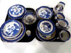 Two trays containing 51 pieces of Booths willow pattern tea and dinner china