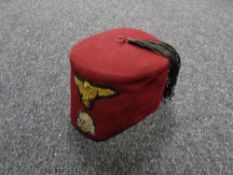 A 20th century fez bearing Third Reich and skull and crossbow sew on patches