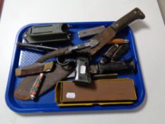 A tray containing a TJ Harrington and Son air pistol together with a collection of assorted knives