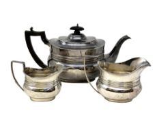 An Edwardian silver harlequin three piece tea service, Edward Barnard & Sons Ltd,