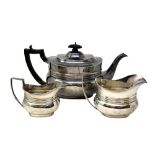 An Edwardian silver harlequin three piece tea service, Edward Barnard & Sons Ltd,