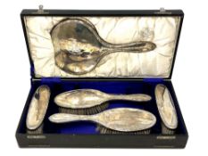 A silver five-piece dressing table set, Chester marks, boxed.