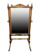 A Regency style mahogany cheval mirror in the manner of Gillows,