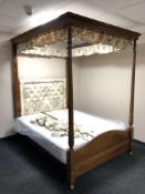 An inlaid mahogany four-poster bed, the carved,