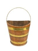 A George III mahogany navette shaped brass bound peat bucket, height 30 cm.