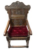 A 17th century carved oak Wainscot armchair, with chip carved chevron detail, the back dated 1661,