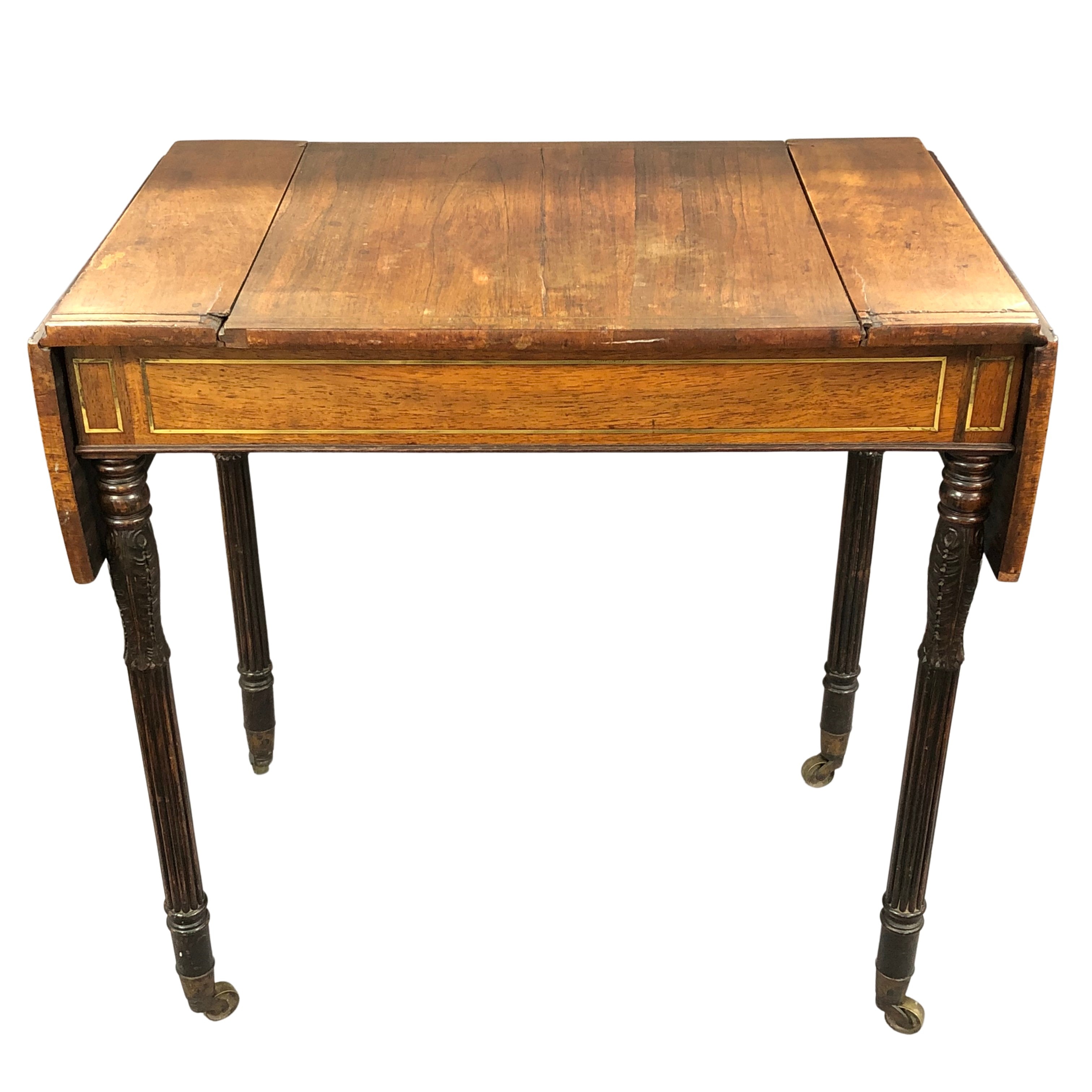 A Regency rosewood games table, inlaid with brass and with drop leaf extensions,