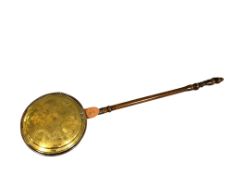 A 19th century brass and copper bed warming pan.