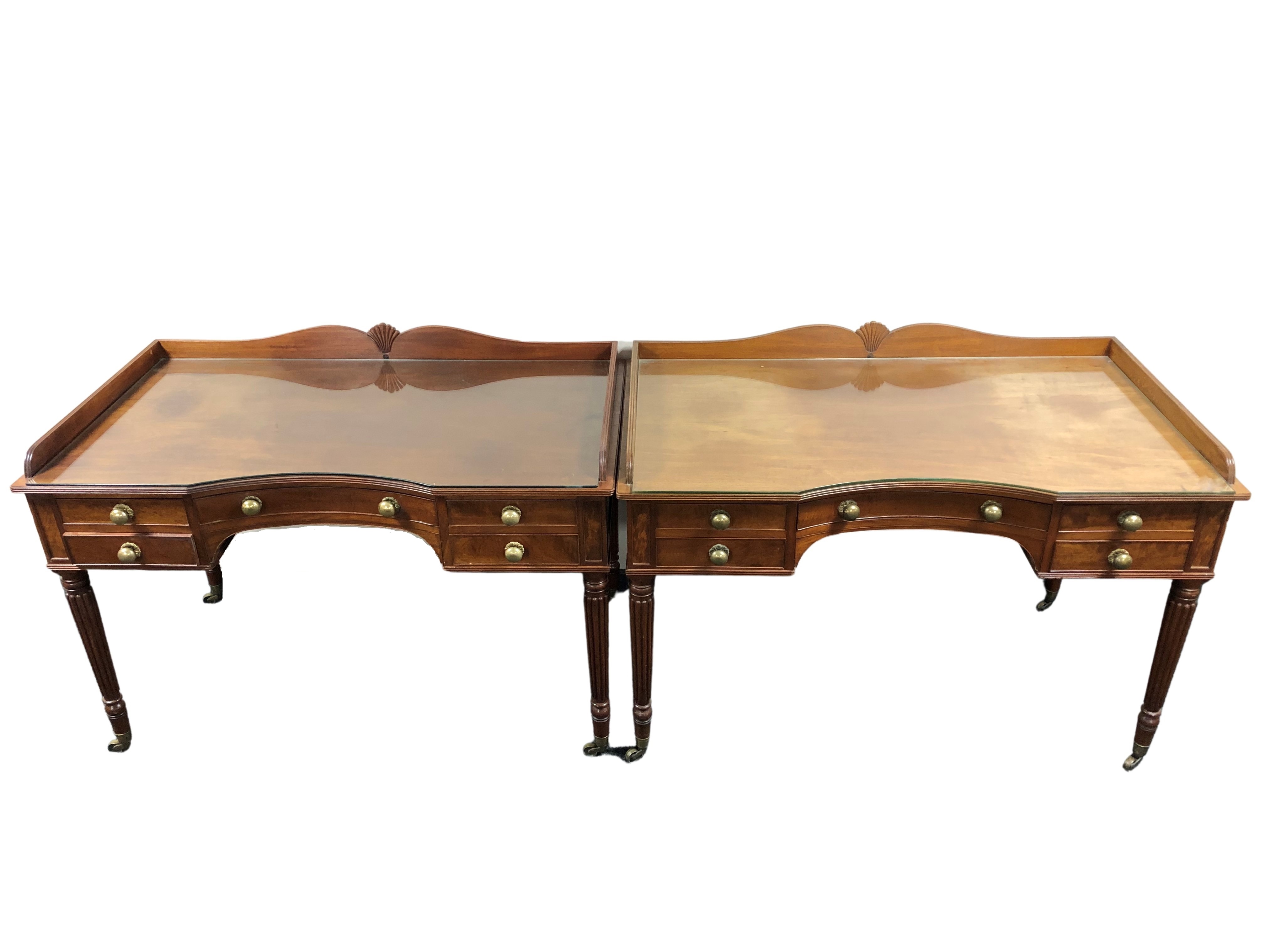 A fine pair of Regency style mahogany dressing tables, in the manner of Gillows,