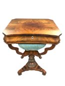 An early 19th century mahogany sewing table, with compartmental interior,