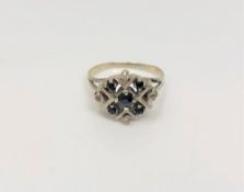 A white gold sapphire and diamond cluster ring,