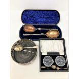 A silver plated wine coaster, pair of cut glass salts, cased pair of plated spoons,