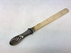 A silver-handled ivory letter opener,