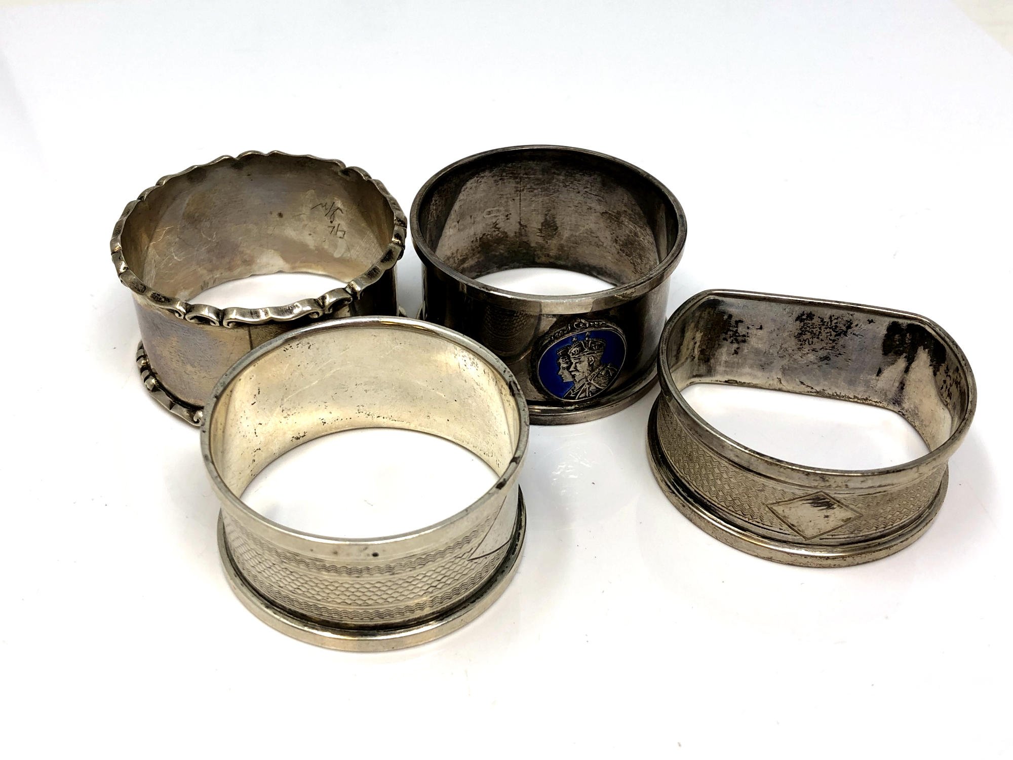 Four assorted silver napkin rings, one enamelled CONDITION REPORT: 56.