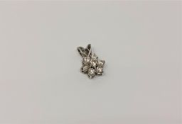 A white gold seven stone diamond cluster pendant, length 15mm CONDITION REPORT: 1.