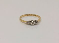 An 18ct gold three stone diamond ring, size O CONDITION REPORT: 1.