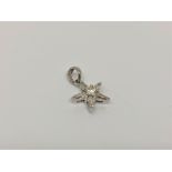 An 18ct white gold diamond star pendant set with central brilliant cut diamond and five baguette