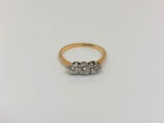 An 18ct gold and platinum three stone diamond ring, approx. 0.