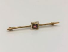 A yellow gold white enamelled and gem stone set pin CONDITION REPORT: 2g