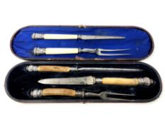 A three piece boxed Victorian carving set with bone handles and ornate silver mounts,