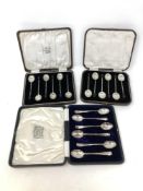 A boxed set of six silver teaspoons and two boxed sets of six silver coffee spoons