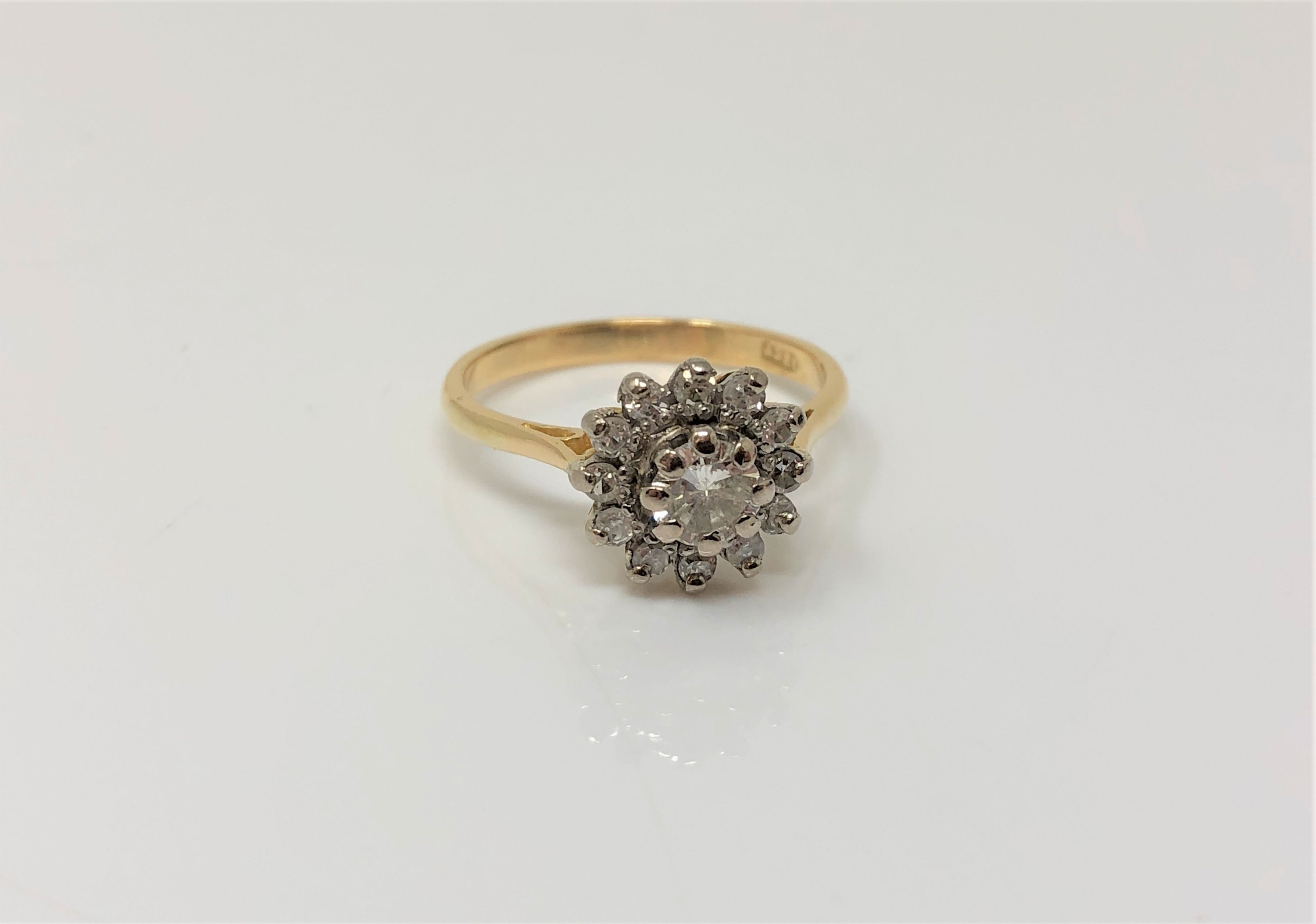 An 18ct gold diamond cluster ring, the central stone approx. 0.