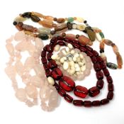 A collection of agate necklaces and cherry amber necklace