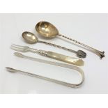 A group of silver cutlery including pair of Georgian tongs,