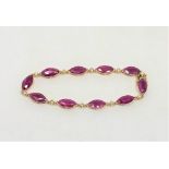 A 14ct yellow gold ruby and diamond bracelet, set with ten marquise-cut rubies (14.