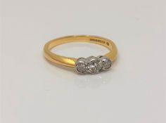 An 18ct gold three stone diamond ring, stated total diamond weight .