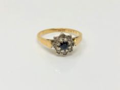 An 18ct gold sapphire and diamond cluster ring, size M CONDITION REPORT: 3.