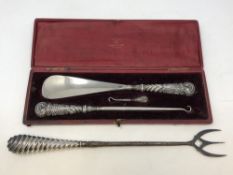 A Victorian cased silver mounted shoehorn and button hooks,