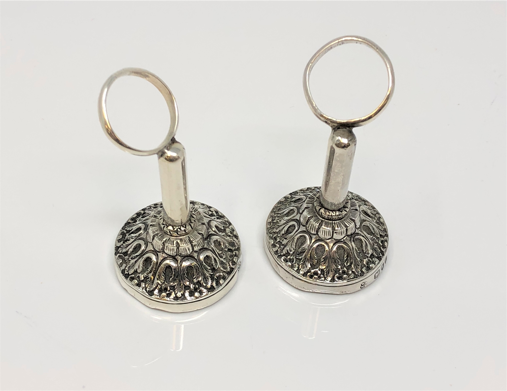 A pair of ornate silver napkin holders,