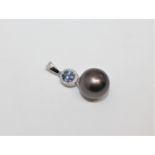 A 14ct white gold pearl, sapphire and diamond pendant, the oval-cut sapphire weighing 0.