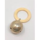 A silver rattle with ivory teething ring,