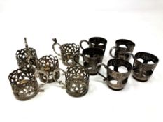 Two sets of five antique silver cup holders.