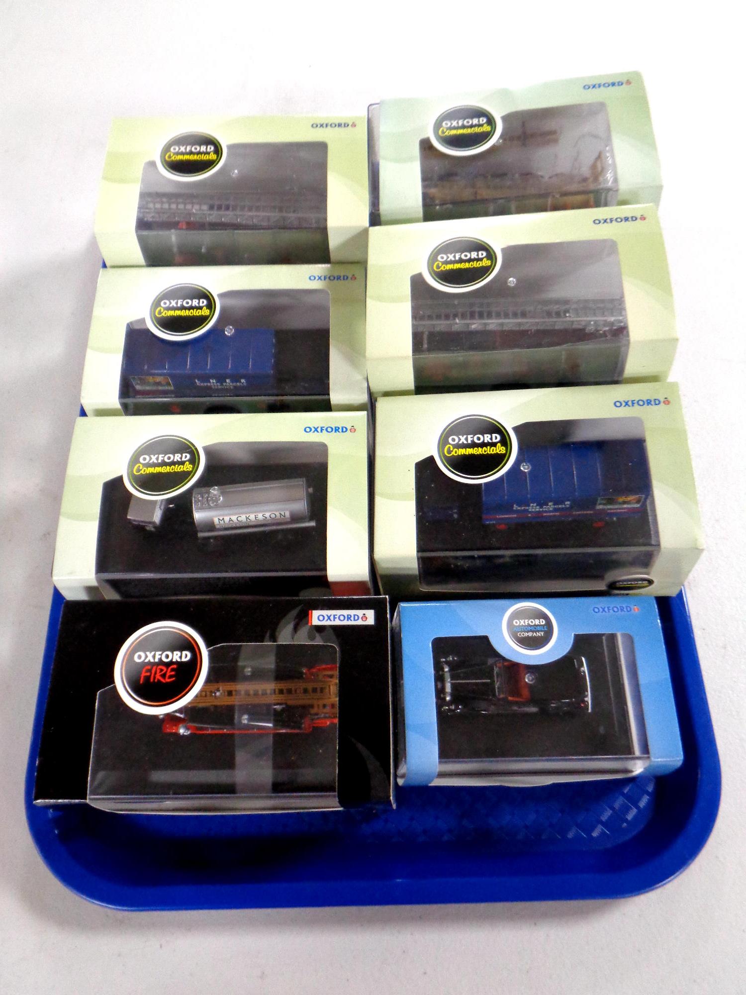 A tray containing eight Oxford die cast delivery and emergency vehicles, classic cars,