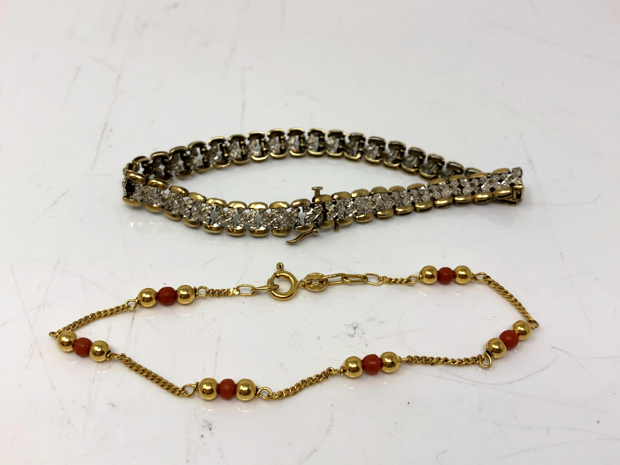 Two gold bracelets set with diamonds and coral. CONDITION REPORT: 12.