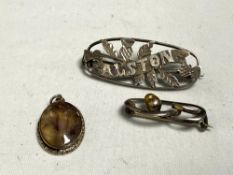 Two silver brooches and a pendant