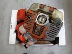 A box containing five petrol brush cutter engines