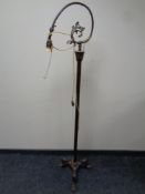 An antique cast iron rise and fall standard lamp (continental wiring)