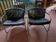 A pair of 20th century black leather and tubular metal armchairs