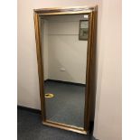A contemporary rectangular golden framed mirror,