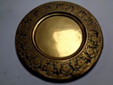 An antique brass embossed plaque