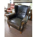 An early 20th century leather wingback armchair